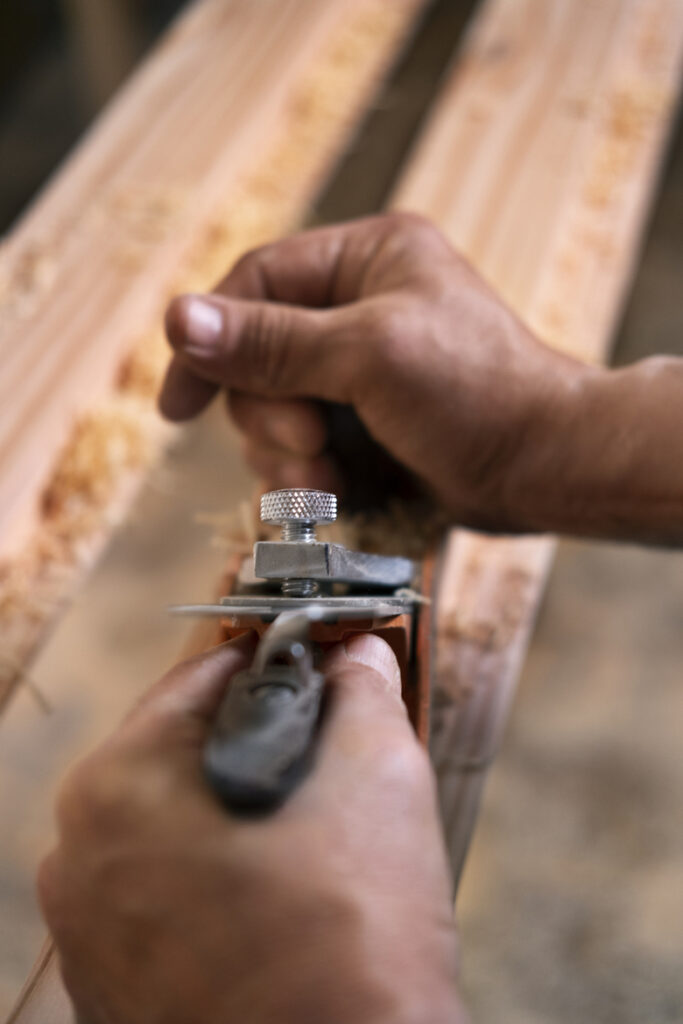male wood worker his shop working with tools equipment